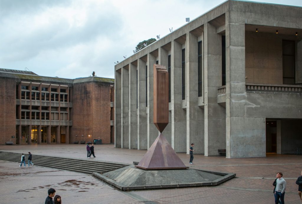 Modern buildings and sculpture in an outdoor courtyard.