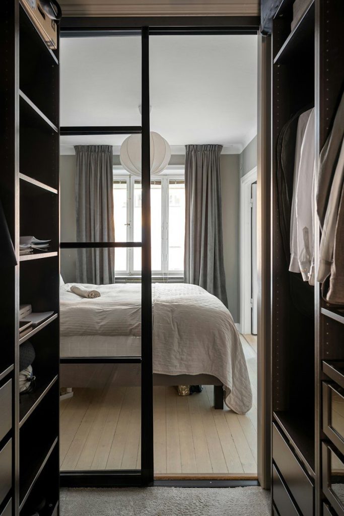 A bedroom with a bed and a closet