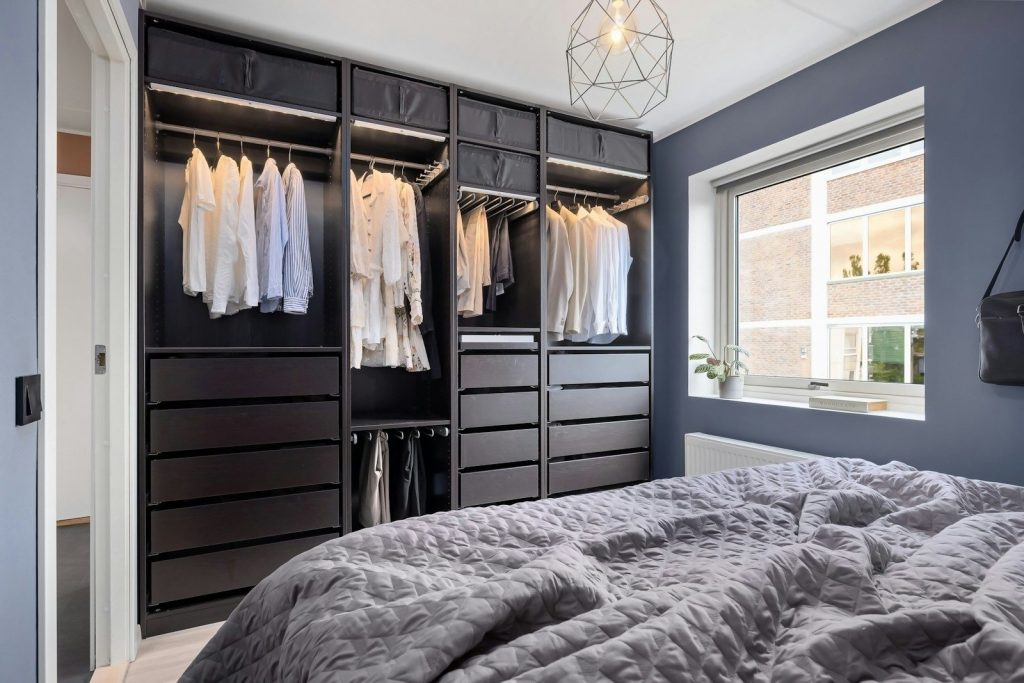 A bedroom with a bed and a closet