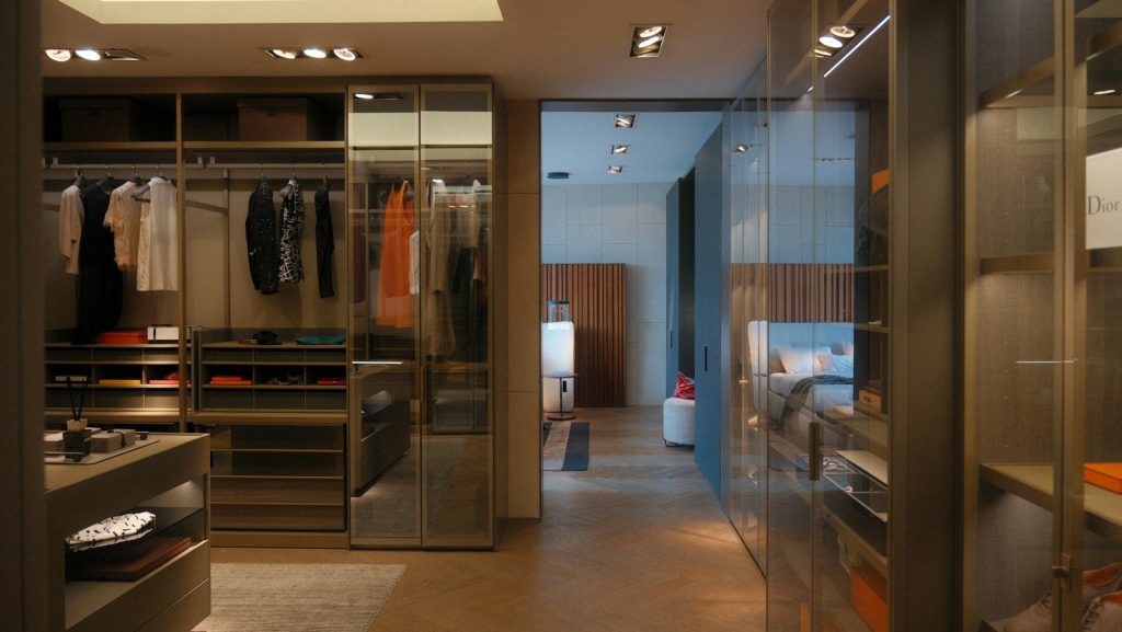 A walk in closet with a lot of clothes